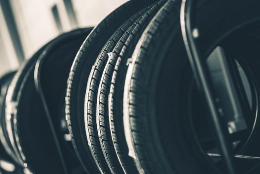Brand New Tires Rack Closeup Photo. Car Tires Market