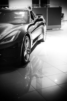 Luxury Super Car For Sale in Dealership Showroom. Black and White Color Grading.