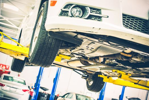 Lifted Car Maintenance. Servicing Car on the Car Lift. Auto Service Theme.