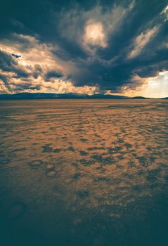 Desert Badlands with Stormy Clouds Above. Vertical Nature Photo.