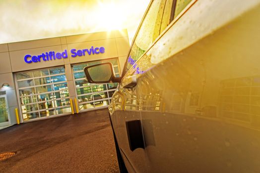 Car Service Auto Care Center. Car in Front of Two Gates to Authorized Certified Auto Service.