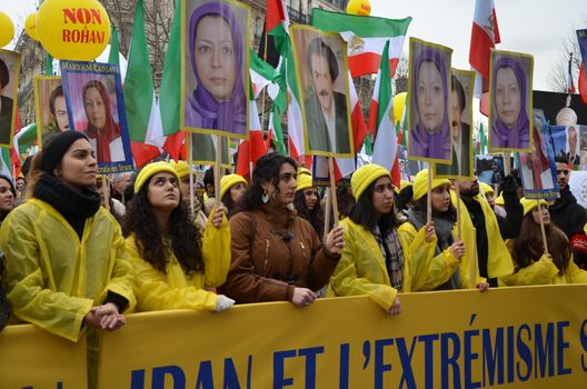 FRANCE, Paris: People raise signs with portrait of Iranian political opponent Maryam Radjavi as they take part in a demonstration denouncing Iran's use of the death penalty, on the occasion of the official visit to France by the Iranian President on January 28, 2016 in Paris at Denfert-Rochereau square. Iranian President Hassan Rouhani begun an official visit to France on January 27, 2016 which is expected to include the signing of an agreement to buy more than 100 planes following talks with President Francois Hollande.