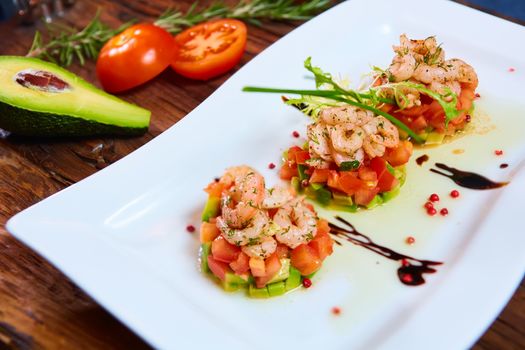 Salad with shrimps, tomato and avocado. Healthy food