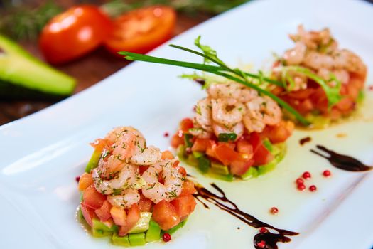 Salad with shrimps, tomato and avocado. Healthy food