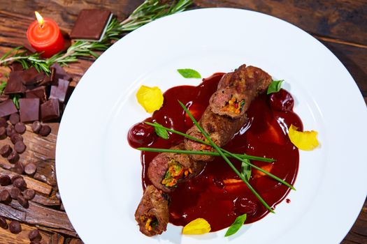 Roasted meat with vegetables and chocolate sauce. Shallow DOF