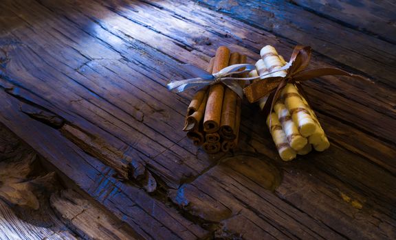 cinnamon sticks on brown wooden tables and red candles
