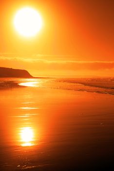 distant cliffs on a sunsey beach in county Kerry Ireland