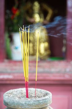 Burning joss sticks in pagoda, Saigon, Vietnam