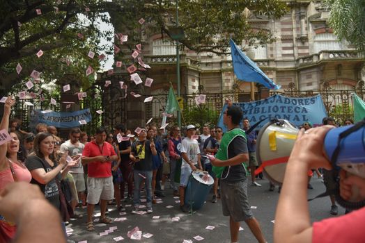 ARGENTINA, Buenos Aires: Demonstrators gathered outside the Ministry of Culture in Buenos Aires, on January 28, 2016, cheering and throwing flyers to protest job cuts.State workers received news of layoffs in various public agencies. 