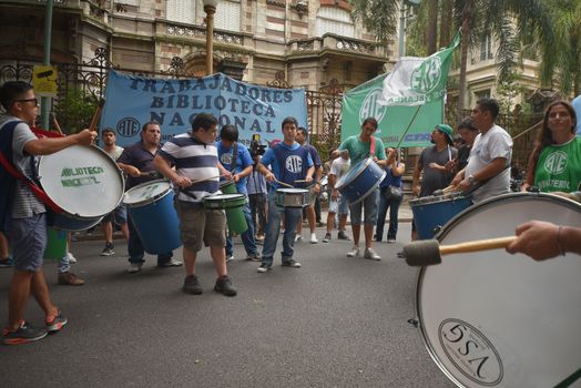 ARGENTINA, Buenos Aires: Demonstrators gather outside the Ministry of Culture in Buenos Aires, on January 28, 2016, chanting and banging drums in protest against job cuts.State workers received news of layoffs in various public agencies. 
