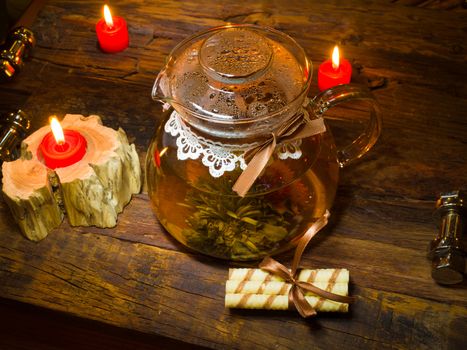The exotic green tea with flowers in glass teapot 