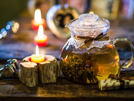 The exotic green tea with flowers in glass teapot 