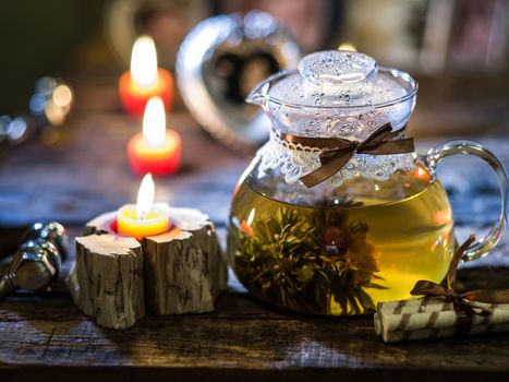 The exotic green tea with flowers in glass teapot 