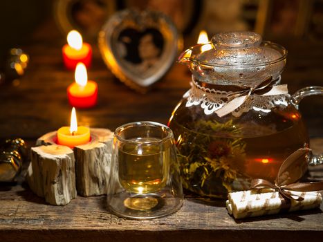 The exotic green tea with flowers in glass teapot  and cup