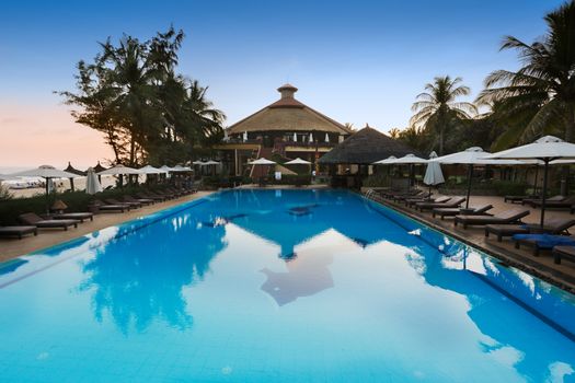 MUI NE, VIETNAM - FEBRUARY 07, 2014: Pool of a seaside resort in Mui Ne - an upcoming touristic area in Southern Vietnam