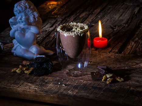 Cup of cacao with chocolate on wooden table