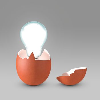 Conceptual picture of a nascent idea. The light bulb is hatching from the eggshell like a newborn idea. Copy space available.