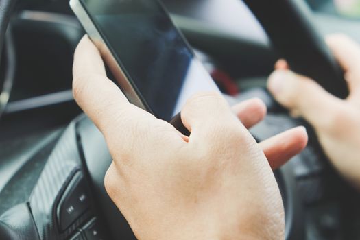 Image of using a mobile phone inside of a car