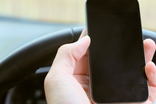 Image of using a mobile phone inside of a car