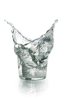 Glass with splashing water on white background. Clipping path is included