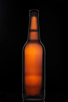 Silhouette of full Bottle brown beer on black background