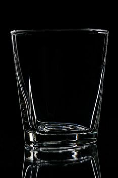 silhouette of Empty glass for whisky on black backgrounds
