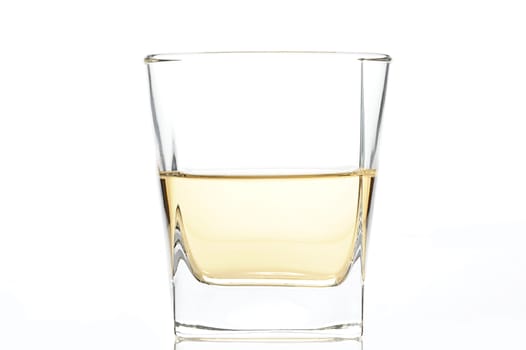 glass with a yellow rum on white background