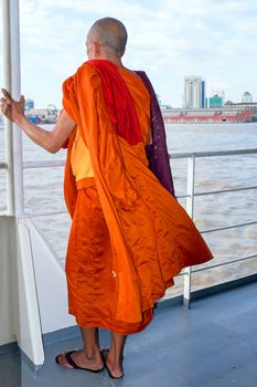 YANGON, MYANMAR - november 24, 2015: Monk on the ferry at Yangon, Myanmar. Buddhism in Myanmar is predominantly of the Theravada tradition, practised by 89% of the country's population.