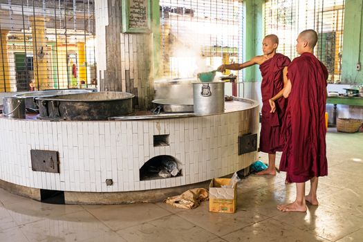 BAGO, MYANMAR -November 26, 2015: Monks preparing lunch in the monastery at Bago Myanmar. Buddhism in Myanmar is predominantly of the Theravada tradition, practised by 89% of the country's population