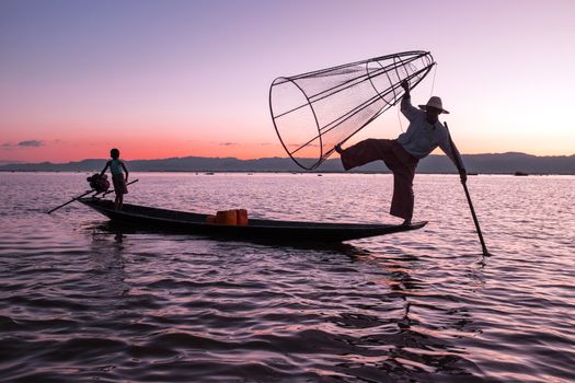 Silhouette of fisherman at sunset Inle Lake Burma Myanmar

