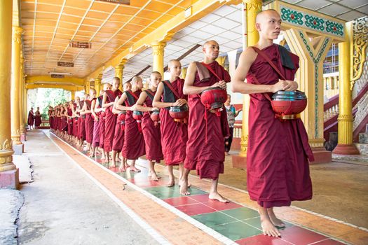 BAGO, MYANMAR -November 26, 2015: Monks going for lunch in the monastery from Bago in Myanmar.