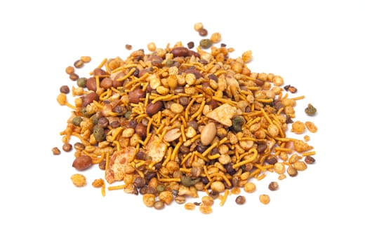Pile of dry roasted Indian snack mix, isolated over white