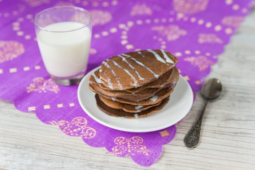 Chocolate pancakes with the glass of milk