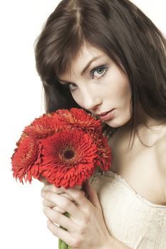 A beautyful woman with a bouquet of red gerbera