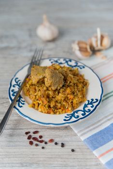 Plate of rice and meat national dish pilau with spices