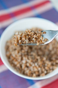 Vertical photo of the buckwheat cereal on the fork