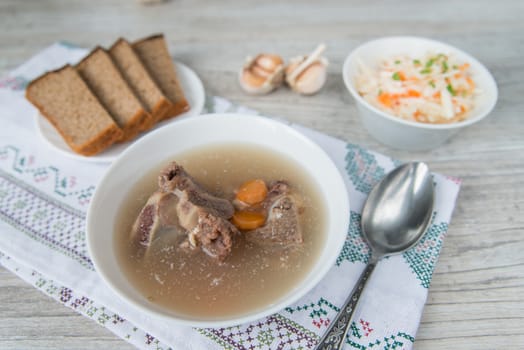 Dinner with the meat bouillon and sauerkraut