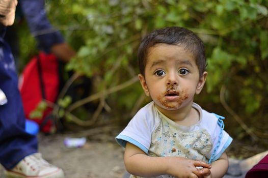 October 4, 2015; Bapska in Serbia. Group of refugees leaving Serbia. They came to Bapska by buses and then they leaving Serbia and go to Croatia and then to Germany. Many of them escapes from home because of civil war. 