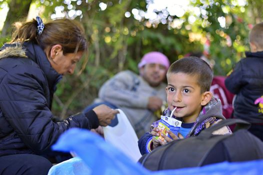 October 4, 2015; Bapska in Serbia. Group of refugees leaving Serbia. They came to Bapska by buses and then they leaving Serbia and go to Croatia and then to Germany. Many of them escapes from home because of civil war. 