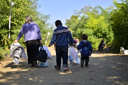 October 4, 2015; Bapska in Serbia. Group of refugees leaving Serbia. They came to Bapska by buses and then they leaving Serbia and go to Croatia and then to Germany. Many of them escapes from home because of civil war. 