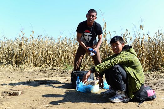 October 6,2015; Hegyeshalom in Hungary. Group of refugees leaving Hungary. They came to Hegyeshalom by train and then they leaving Hungary and go to Austria and then to Germany. Many of them escapes from home because of civil war. 