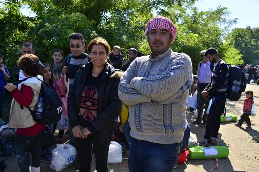 October 4, 2015; Bapska in Serbia. Group of refugees leaving Serbia. They came to Bapska by buses and then they leaving Serbia and go to Croatia and then to Germany. Many of them escapes from home because of civil war. 