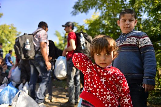 October 4, 2015; Bapska in Serbia. Group of refugees leaving Serbia. They came to Bapska by buses and then they leaving Serbia and go to Croatia and then to Germany. Many of them escapes from home because of civil war. 