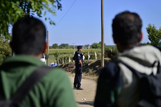 October 4, 2015; Bapska in Serbia. Group of refugees leaving Serbia. They came to Bapska by buses and then they leaving Serbia and go to Croatia and then to Germany. Many of them escapes from home because of civil war. 