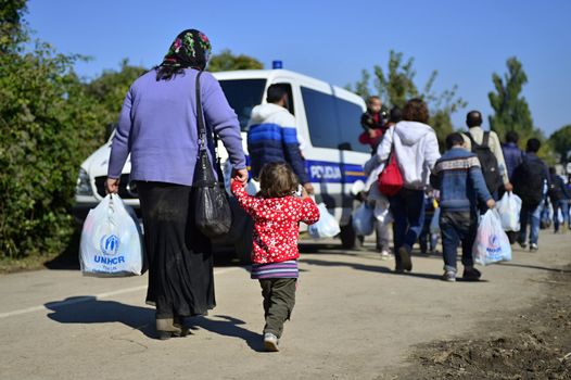 October 4, 2015; Bapska in Serbia. Group of refugees leaving Serbia. They came to Bapska by buses and then they leaving Serbia and go to Croatia and then to Germany. Many of them escapes from home because of civil war. 