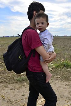 October 4, 2015; Sid in Serbia. Group of Afghan refugees leaving Serbia. They came to Sid by taxi and then they leaving Serbia and go to Croatia and then to Germany. Many of them escapes from home because of civil war. 