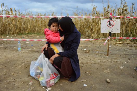 October 4, 2015; Bapska in Serbia. Group of refugees leaving Serbia. They came to Bapska by buses and then they leaving Serbia and go to Croatia and then to Germany. Many of them escapes from home because of civil war. 