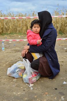 October 4, 2015; Bapska in Serbia. Group of refugees leaving Serbia. They came to Bapska by buses and then they leaving Serbia and go to Croatia and then to Germany. Many of them escapes from home because of civil war. 