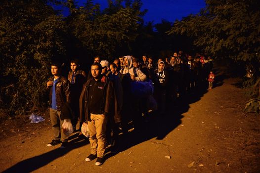October 4, 2015; Bapska in Serbia. Group of refugees leaving Serbia. They came to Bapska by buses and then they leaving Serbia and go to Croatia and then to Germany. Many of them escapes from home because of civil war. 