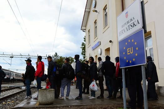 October 6,2015; Hegyeshalom in Hungary. Group of refugees leaving Hungary. They came to Hegyeshalom by train and then they leaving Hungary and go to Austria and then to Germany. Many of them escapes from home because of civil war. 